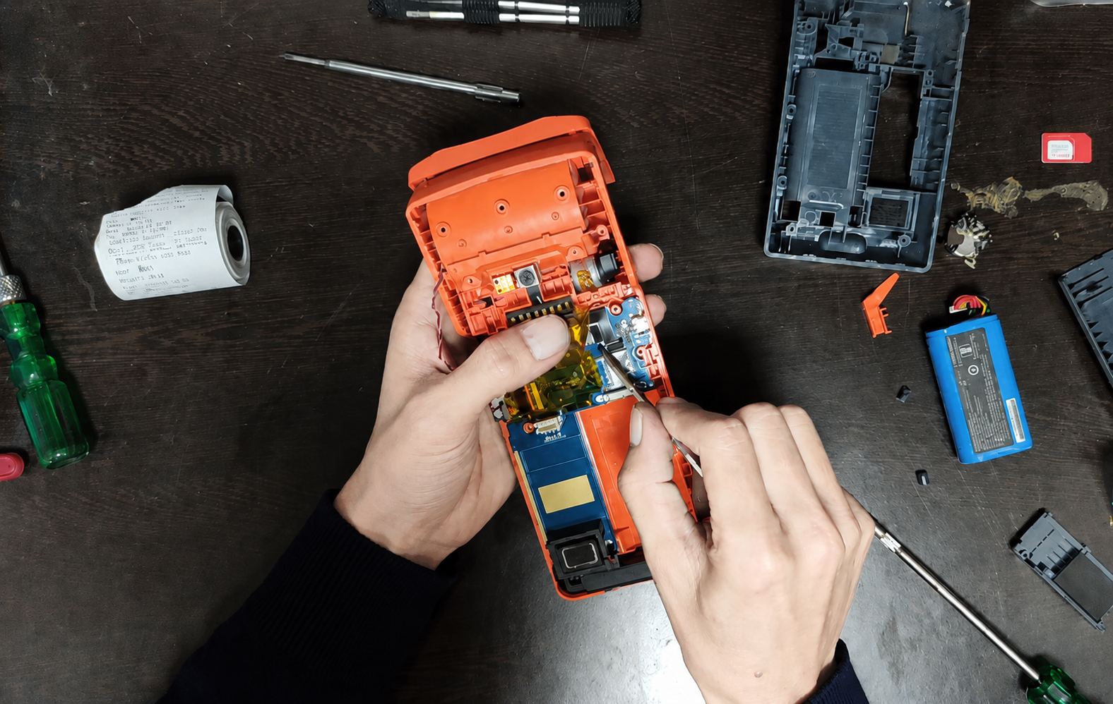 Mipos technician repairing a Sunmi device at the workshop